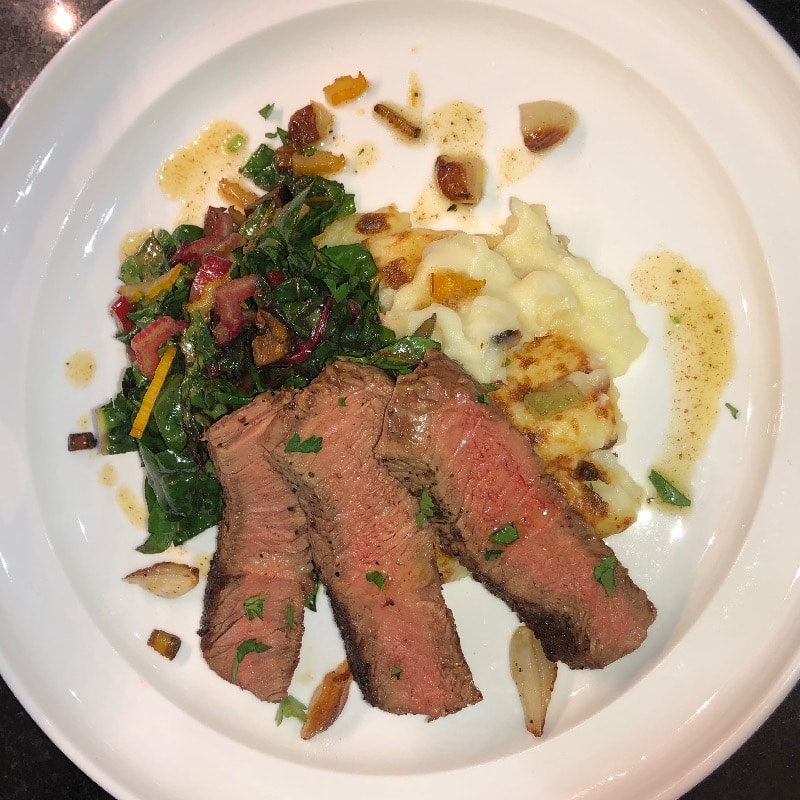 Grass fed NY strip potatoes rainbow chard garlic butter sauce