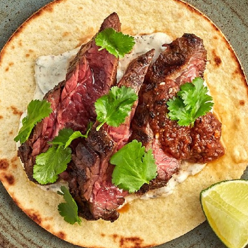 Beef onglet taco with spring onion crema, morita salsa and coriander