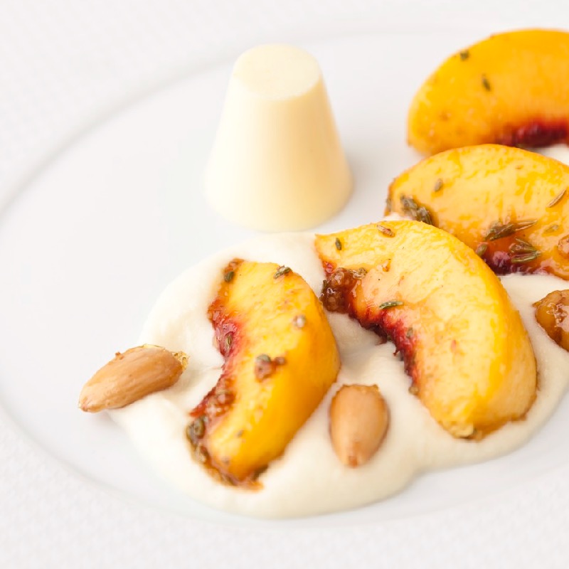 Grilled peaches, white chocolate rabdi and cardamom panna cotta