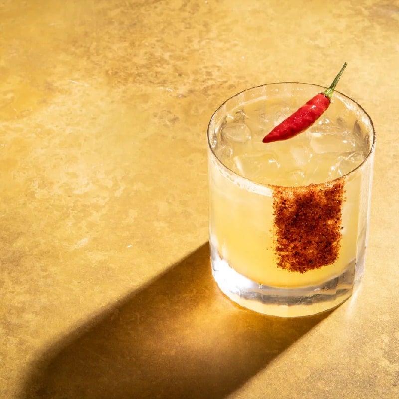 Pineapple and lime rum punch with spiced citrus sugar