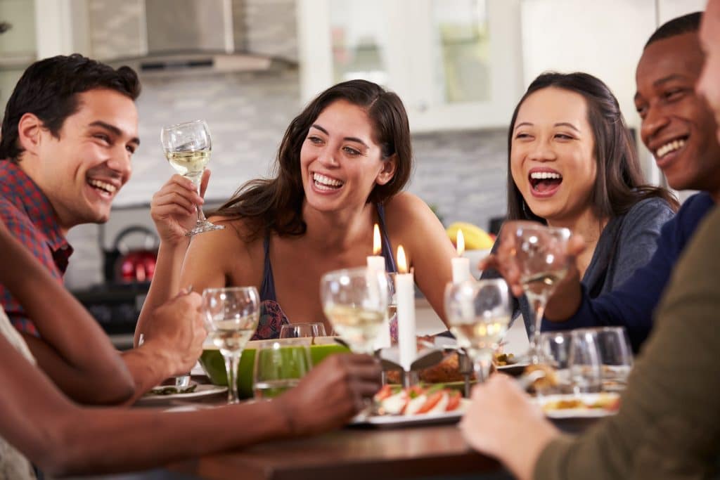 Group Of Friends Enjoying Dinner Party At Home Table at Home Private